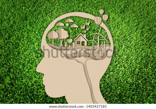 Paper cut of eco concept on green grass\
background. Think green. Save the\
earth.