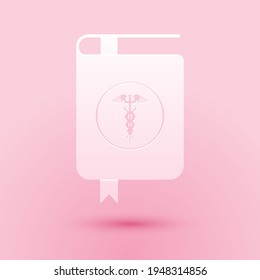 Paper Cut Medical Book And Caduceus Medical Icon Isolated On Pink Background. Medical Reference Book, Textbook, Encyclopedia. Scientific Literature. Paper Art Style.