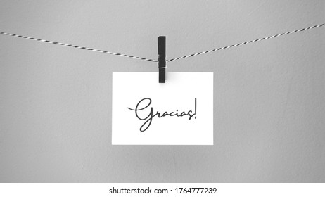 Paper Hanging On A Rope With A Brooch With The Phrase Thank You Written In Spanish. Inspirational Quote.  Thank You Card, Banner, Poster Or Design. Copy Space.