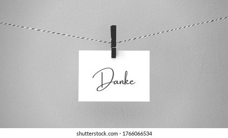 Paper Hanging On A Rope With A Brooch With The Phrase Thank You Written In German. Inspirational Quote.  Thank You Card, Banner, Poster Or Design. Copy Space.