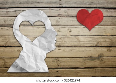 Paper humans head with heart on wood deck background