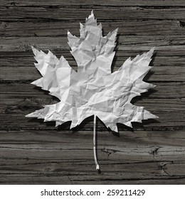 Paper Leaf On An Old Rustic Wood Background As A Symbol Of Nature And Recycling Or A Pulp And Paper Industry Icon.