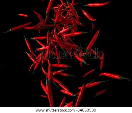 Paprika: red chilli pepper flow over black background