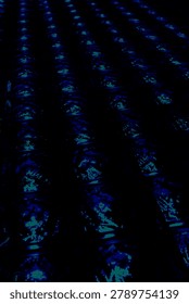 A pattern of blue wave oscillations displayed at an angle and receding into the distance
