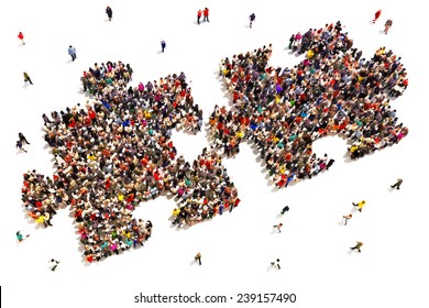 People putting the pieces together concept . Large group of people in the shape of two puzzle pieces on a white background.