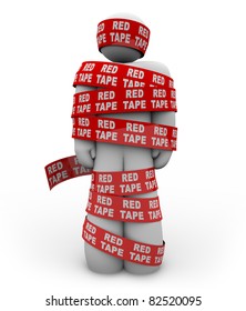 A Person Is Wrapped Up In Red Ribbon With The Words Red Tape Repeated, Representing Getting Caught Up In A Mess Of Bureaucratic Rules, Regulations And Procedures While Trying To Get Something Done