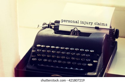 Personal Injury Claims Message On A White Background Against Typewriter On A Table