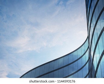 Perspective of high rise building and dark steel window system with clouds reflected on the glass.Business concept of future architecture,lookup to the angle of the building corner. 3d rendering