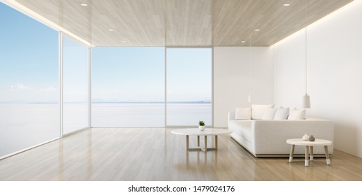 Perspective Of Modern Luxury Living Room With White Sofa On Sea View Background,Relaxation Idea Of Family Vacation, Architecture Idea Of Large Window System - 3D Rendering.