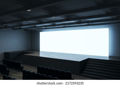 Perspective view on big blank white illuminated screen with place for your text or logo and blue backlit in empty huge hall with scene, stairs and rows of seats. 3D rendering, mock up
