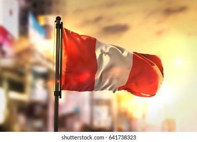 Peru Flag Against City Blurred Background At Sunrise Backlight 3D Rendering - Powered by Shutterstock