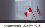 Peru and USA flags on table. Negotiation between Peru and United States. on little blur background. 3D work and 3D image