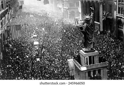 Philadelphia celebrating the armistice ending WWI. Thousands massed on all sides of the replica of the Statue of Liberty on Broad Street on Nov. 11, 1918.