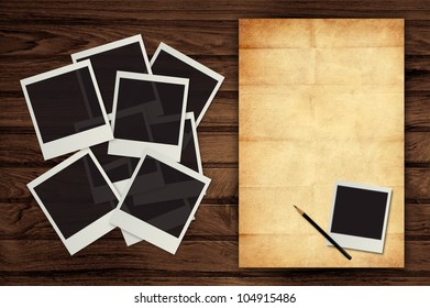 photo frame and pencil with vintage paper on wooden background - Shutterstock ID 104915486