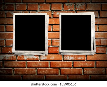 Photo frames on the brick wall