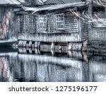 Photo illustration of an old Maine grist mill in winter, with mill pond