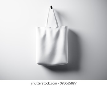 Photo White Cotton Textile Bag Hanging Center. Empty Abstract Wall Background. Highly Detailed Texture, Space For Advertising. Horizontal. 3D Rendering