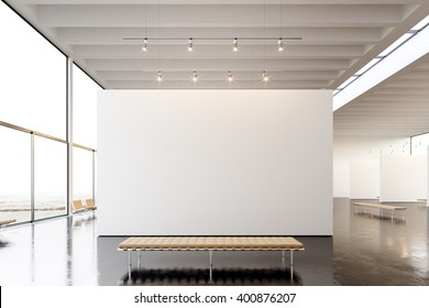 Picture Exposition Modern Gallery,open Space.Blank White Empty Canvas Hanging Contemporary Art Museum.Interior Loft Style Concrete Floor,light Spots,generic Design Furniture And Building.3d Rendering