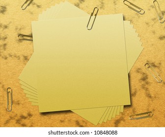 a pile of post it notes held together with a paperclip against a wooden desk surface background