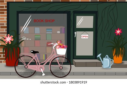 A Pink Bicycle Is Parked Outside A Green Bookstore. There Are Books And Flowers In The Window.