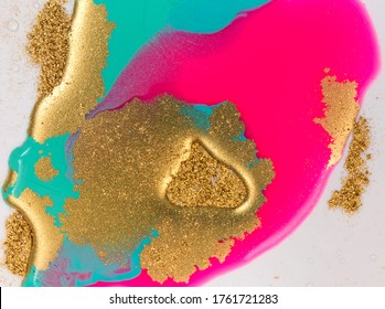 Pink, Gold And Blue Mixed Inks Spilled On White Paper Background. Golden Glitter Texture.