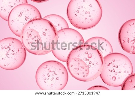 Pink translucent spheres with internal bubbles floating in liquid, ideal for beauty campaigns, cosmetic science visuals, and soft modern abstract design use