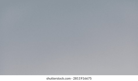 A plain, featureless blue-gray color gradient devoid of subjects or objects that lightens slightly toward the bottom center, creating a soft, almost imperceptible vignette effect.