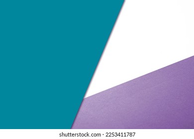 Plain vs textured color papers intersecting to form triangle shape for cover design