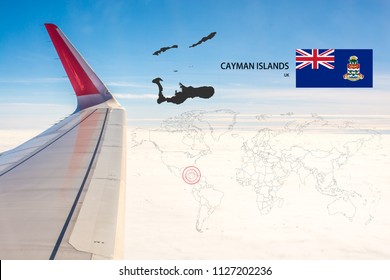 Plan on traveling long distances to Cayman Islands (UK).The tail of the plane and Cayman Islands (UK) map on a world map with flag,On the backdrop is the sky and clouds.