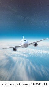 A Plane flying above the clouds and under the stars