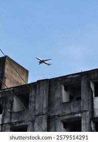 Plane, flying through the building. 