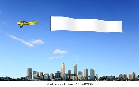 Plane In The Sky Above The City With Blank Flag