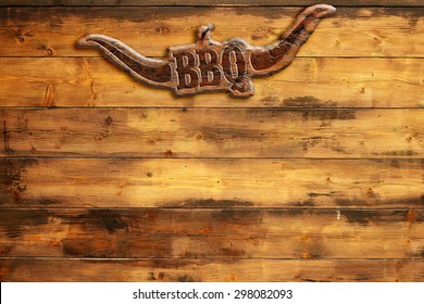 plaque "bbq" nailed to a wooden board