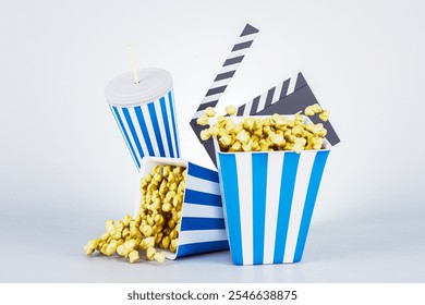 Popcorn bucket, spilled popcorn, soda cup, and clapperboard, all isolated on a light gradient background. Concept of cinema, movie time. 3D Rendering - Powered by Shutterstock