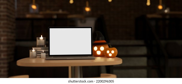 Portable Laptop Computer White Screen Mockup And Halloween Decor, Pumpkin Lamp And Candles On A Table Over Dark Background. 3d Rendering, 3d Illustration