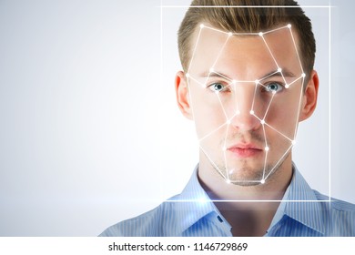 Portrait of attractive young businessman with facial recognition system. Authentication and information concept 