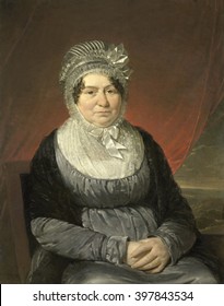 Portrait Of Mrs. Brak-Haskenhoff, By Cornelis Kruseman, 1818, Dutch Painting, Oil On Canvas. A Middle Aged Seated Woman Wears An Empire Waisted Gray Dress With A Black Shawl And Elaborate Hat