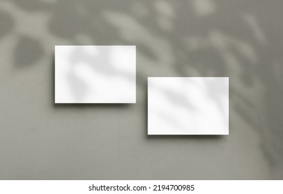 Postcard mockup empty double sided template with overlay shadow on a textured background. Blank paper card for design