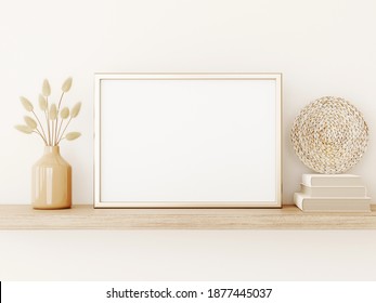 Poster art mockup with horizontal gold metal frame, dried grass in vase, basket plate and books on empty warm beige wall background. Boho interior decoration. A4, A3 format. 3d rendering, illustration