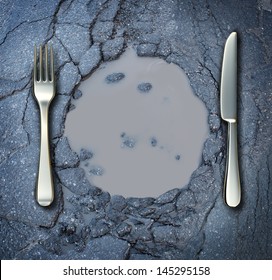 Poverty and hunger concept with a fork and knife on a broken asphalt road shaped as a dinner plate as a social crisis of food shortage hardships and living poor on the streets as a health risk.