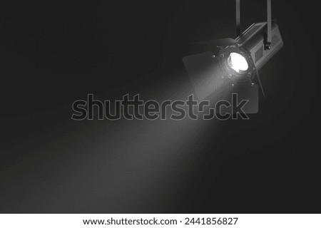 Powerful studio light shining in the darkness. 3D Illustration