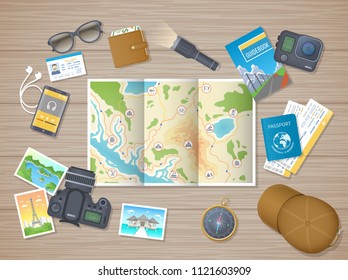 Preparing for hiking tour, vacation, travel. Planning, packing check list. Wooden table with tourist map, guidebook, tickets, passport, flashlight, action camera, compass, cap.  - Powered by Shutterstock