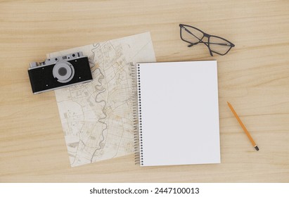 Preparing for tour, vacation, travel. Planning, packing check list. Wooden table with tourist map, guidebook, book plan, flashlight, action camera, . Wooden table top view - Powered by Shutterstock