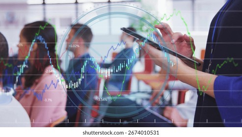 Presenter in blue blazer tapping tablet in meeting room, with financial charts, copy space. Corporate, training, business, technology, professional, data, finance