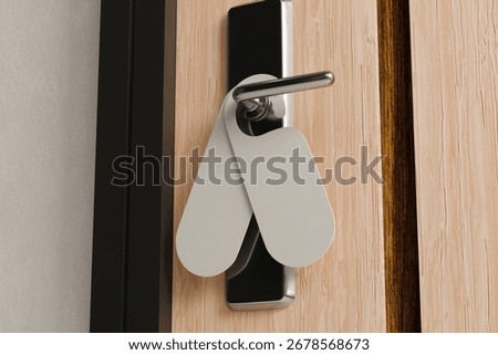 Presenting two customizable blank door hangers on a sleek, modern hotel room door handle, ideal for privacy or service messages