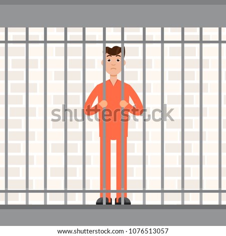 The prisoner behind bars. Convict inside jail