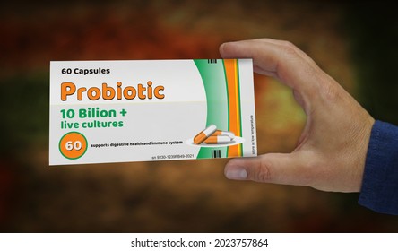 Probiotic Pack Production. Medical Antibiotic Therapy Drug Box In Hand. Abstract Concept 3d Rendering Illustration. Live Bacteria Cultures For Healthy Microbiome Flora And Gut Microbiota.