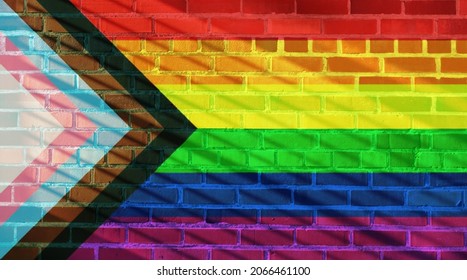 Progress Pride Flag Projected On A Sunny Brick Wall Background