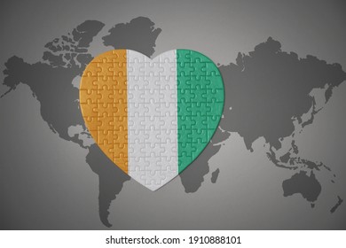 puzzle heart with the national flag of cote divoire on a world map background. 3D illustration