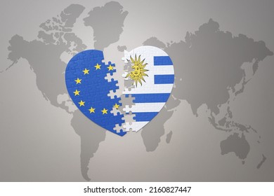 puzzle heart with the national flag of european union and uruguay on a world map background. Concept. 3D illustration
